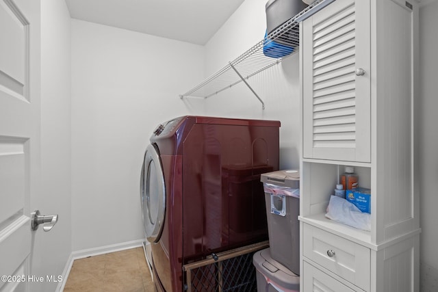 clothes washing area featuring washing machine and clothes dryer and light tile patterned floors