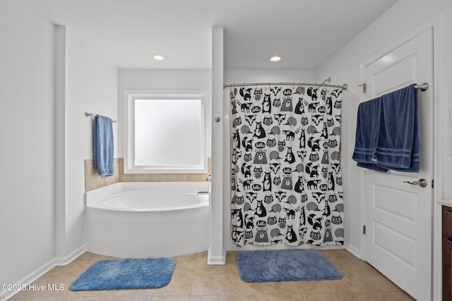 bathroom with tile patterned floors, plus walk in shower, and vanity