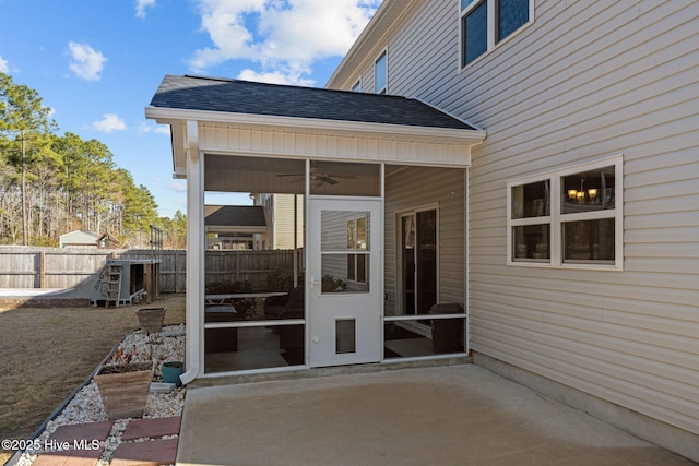 view of patio featuring a sunroom and ceiling fan