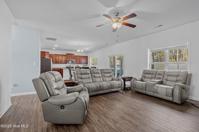 living room with dark hardwood / wood-style floors, a wealth of natural light, and ceiling fan