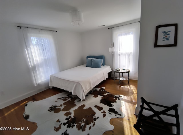 550 E Main St, Belhaven, NC 27810 - bedroom featuring baseboards, wood finished floors, and visible vents