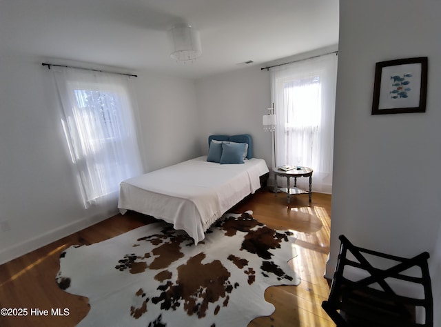 bedroom with hardwood / wood-style flooring