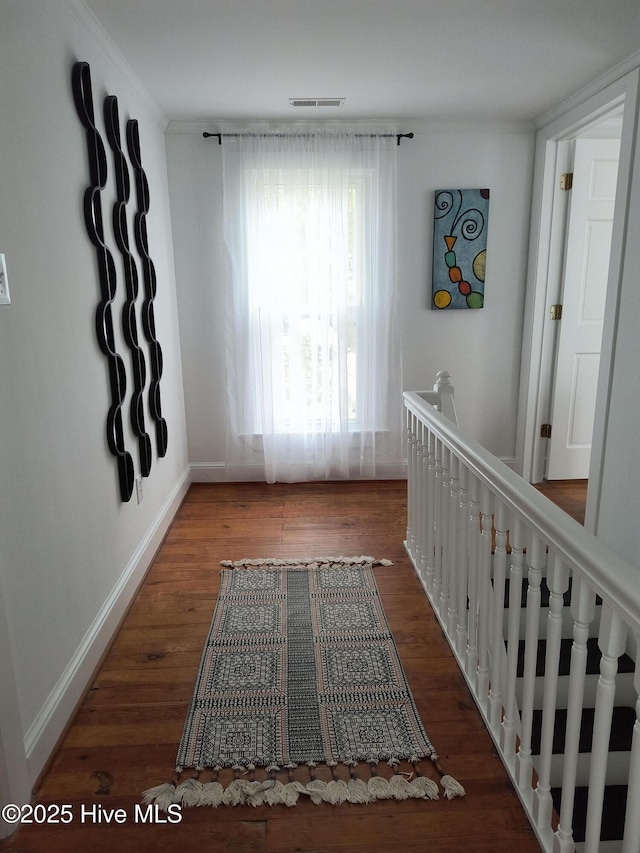 550 E Main St, Belhaven, NC 27810 - corridor with wood finished floors, an upstairs landing, baseboards, ornamental molding, and visible vents