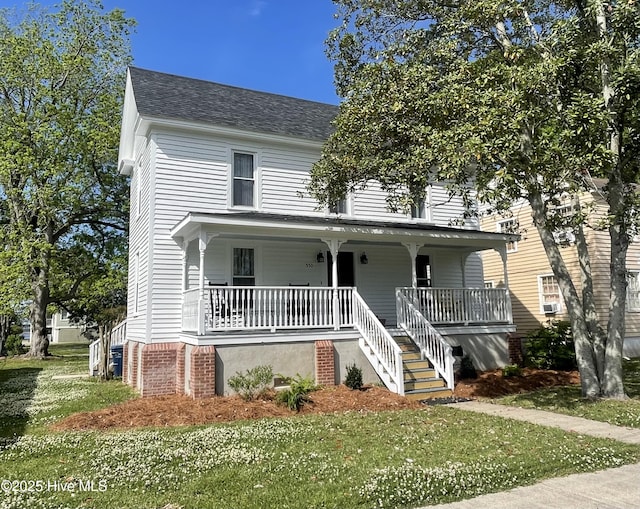 550 E Main St, Belhaven, NC 27810 - view of front of home with a porch, a front yard, stairway, and roof with shingles