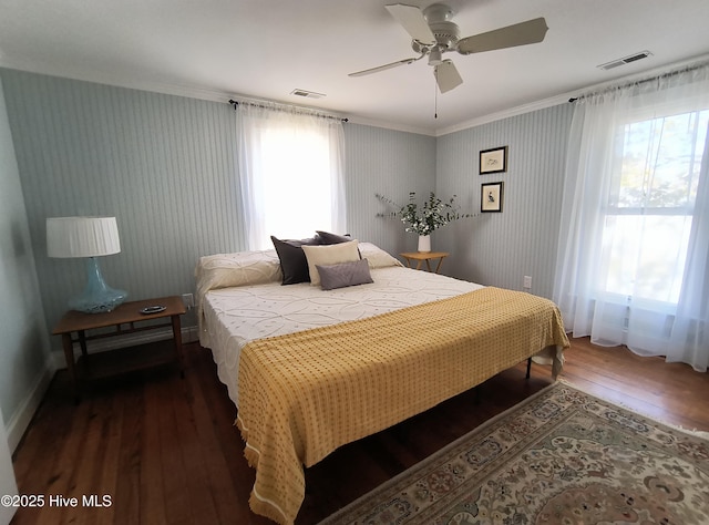 bedroom with ceiling fan, dark hardwood / wood-style flooring, and multiple windows