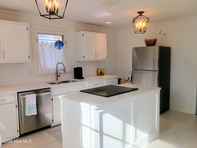 550 E Main St, Belhaven, NC 27810 - kitchen with a sink, stainless steel appliances, white cabinetry, a notable chandelier, and a kitchen island