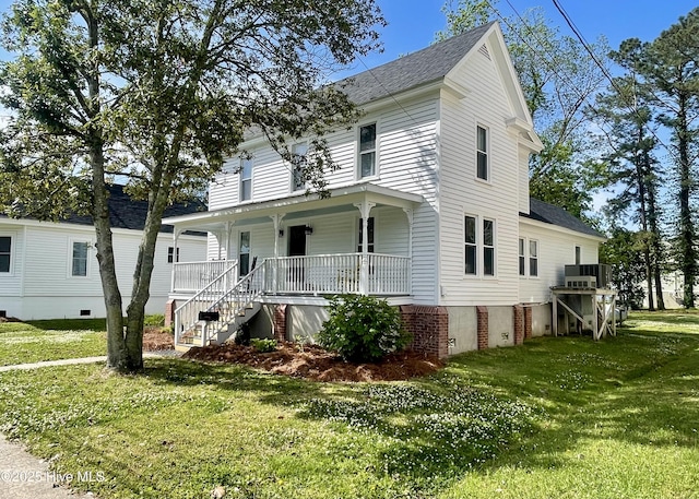 550 E Main St, Belhaven, NC 27810 - view of front of property with a front lawn, crawl space, a shingled roof, stairway, and covered porch