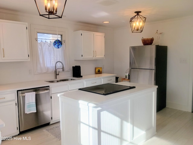 kitchen with pendant lighting, stainless steel appliances, a kitchen island, and white cabinets