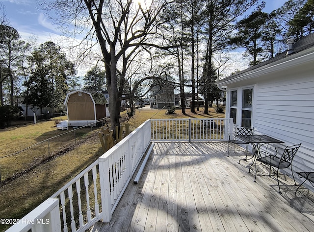 deck with a storage unit and a yard