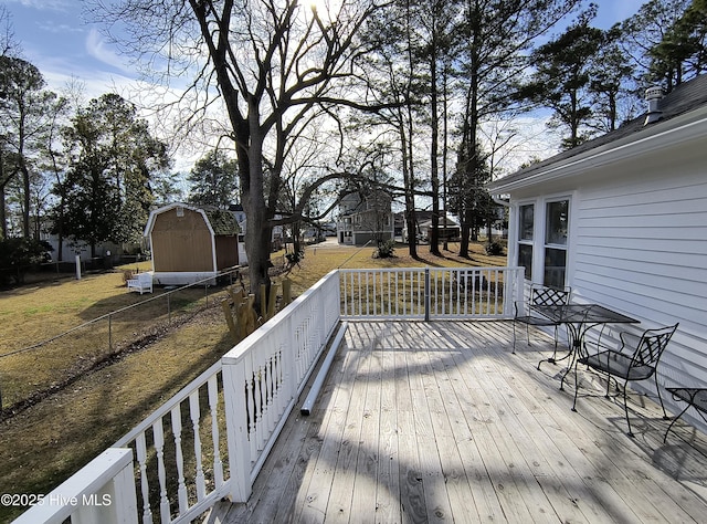 550 E Main St, Belhaven, NC 27810 - wooden deck featuring fence, an outbuilding, and a storage shed