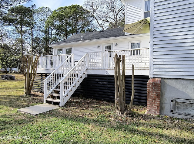 rear view of property featuring a wooden deck