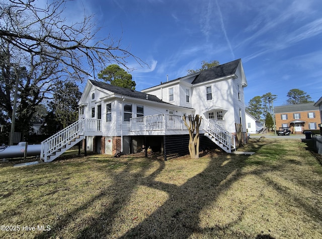 back of house with a lawn and a deck