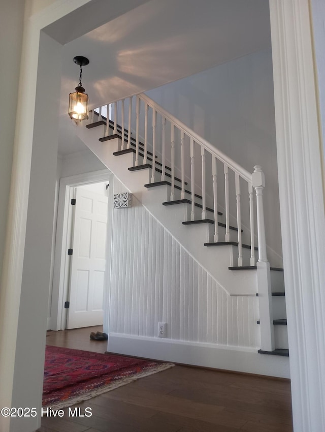 staircase with hardwood / wood-style floors