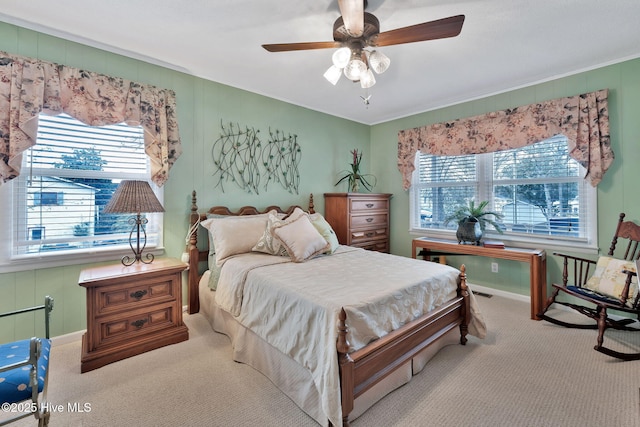 bedroom featuring multiple windows, ceiling fan, and carpet