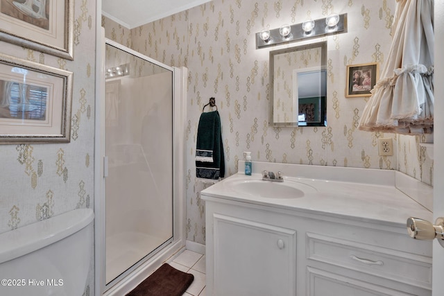 bathroom with a shower with door, vanity, tile patterned floors, and toilet