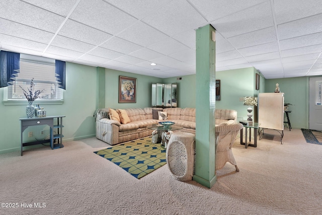 living room with carpet flooring and a drop ceiling