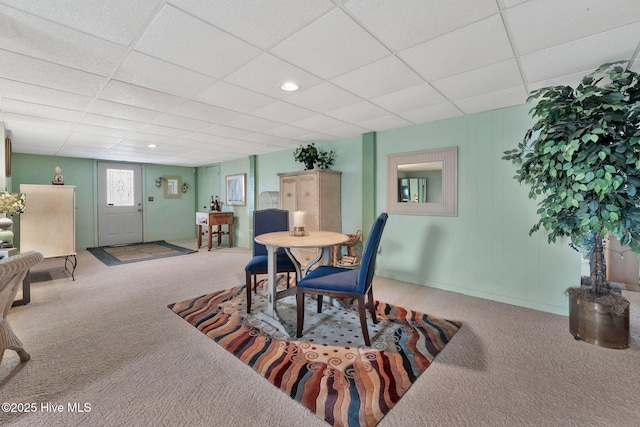 dining room with carpet flooring and a drop ceiling