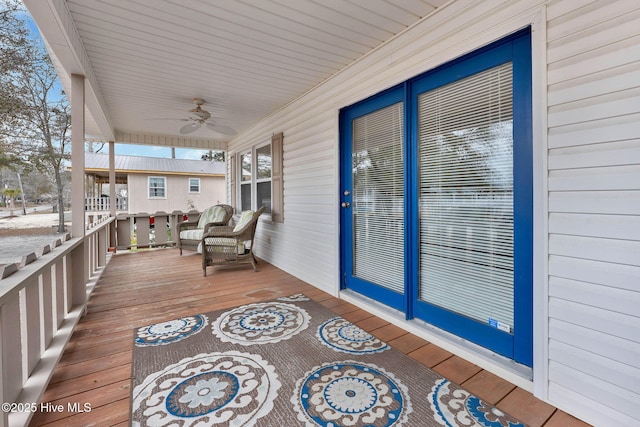 deck with ceiling fan and a porch