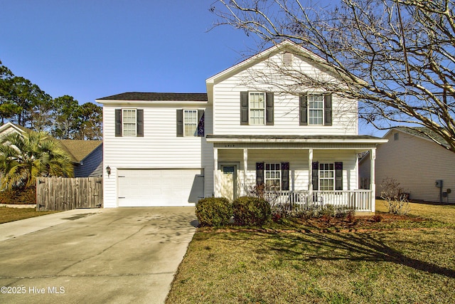 view of property with covered porch, a front yard, and a garage