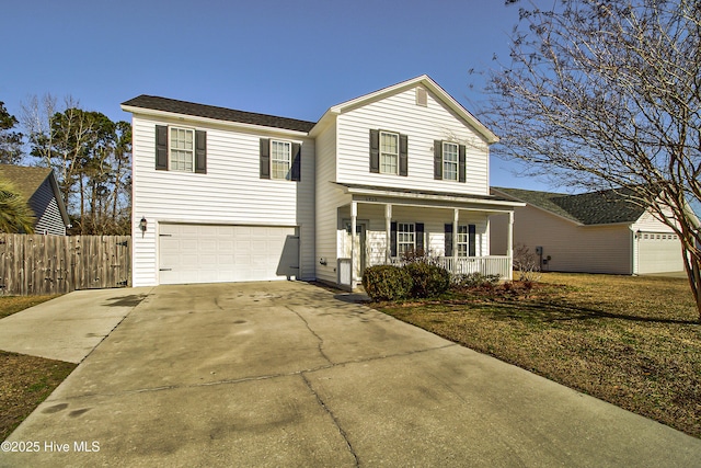 view of property featuring a front lawn, a garage, and a porch