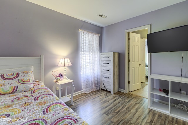 bedroom with hardwood / wood-style flooring