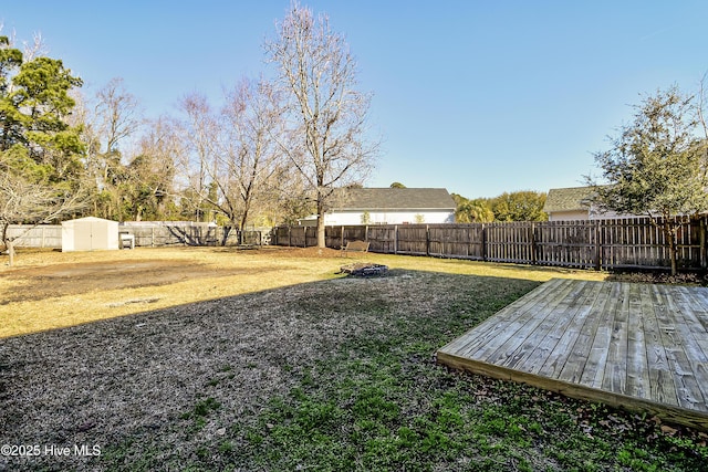 view of yard with a storage unit and a wooden deck