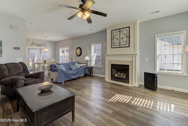 living room featuring a fireplace, ceiling fan, and hardwood / wood-style floors