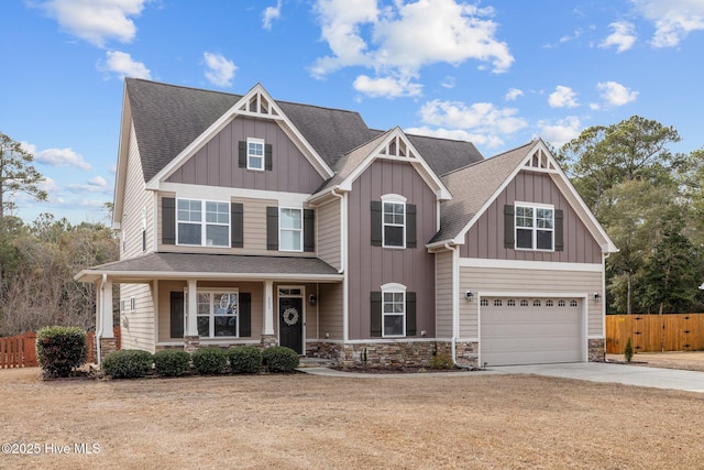 craftsman-style home with a garage, a front yard, and covered porch