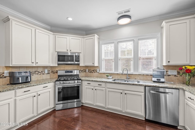 kitchen featuring stainless steel appliances, sink, dark wood-type flooring, and white cabinets