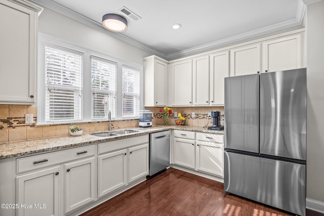 kitchen with white cabinetry, sink, light stone counters, and appliances with stainless steel finishes