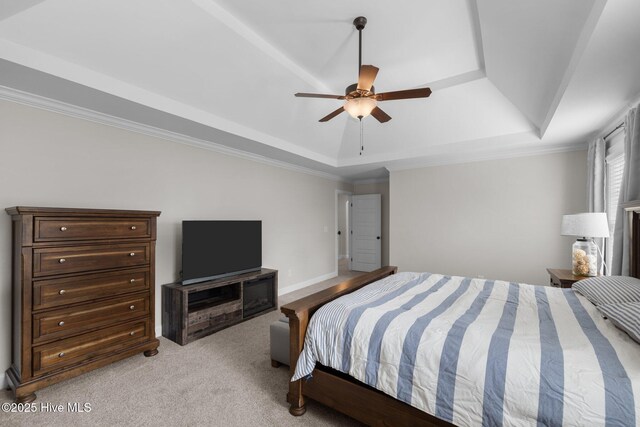 carpeted bedroom featuring ceiling fan, ornamental molding, and a tray ceiling