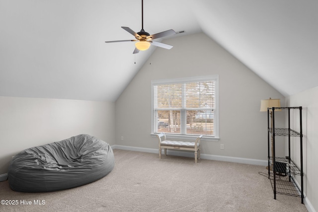 sitting room featuring vaulted ceiling, light colored carpet, and ceiling fan