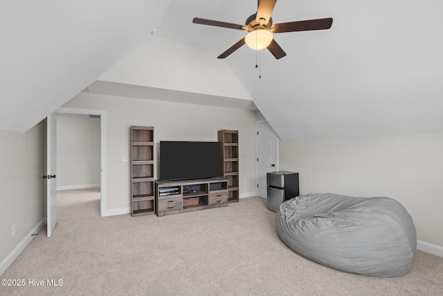 living area featuring lofted ceiling and carpet