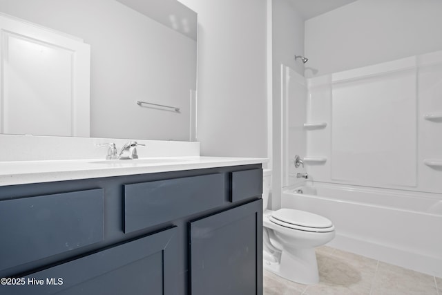 bathroom featuring tile patterned flooring, shower / bath combination, vanity, and toilet