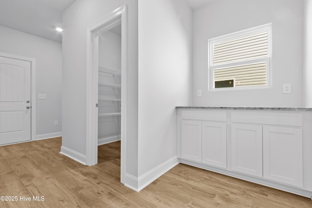 interior space with light wood-type flooring and baseboards