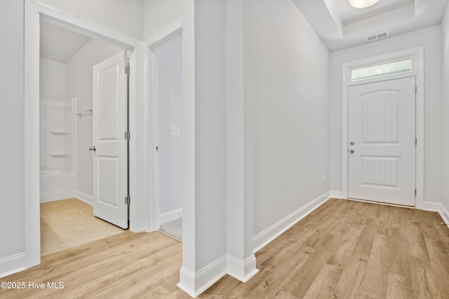 entrance foyer with baseboards, visible vents, and light wood-style floors