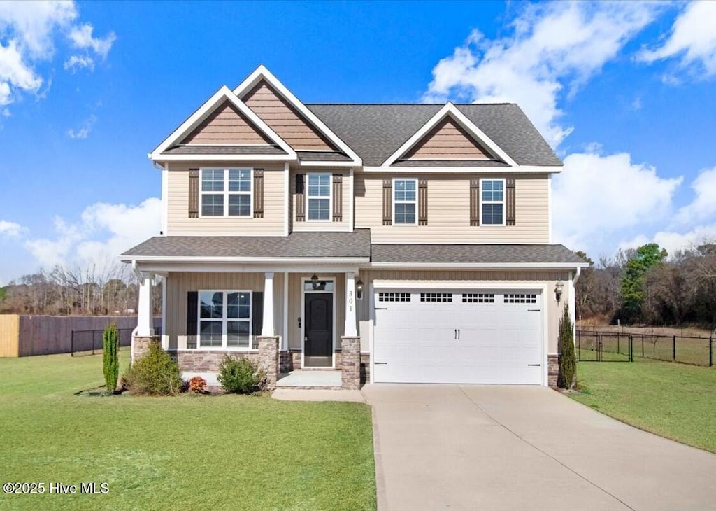 craftsman-style home featuring a garage, a front lawn, and a porch