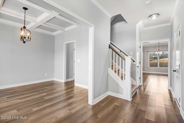 foyer entrance with beam ceiling, coffered ceiling, ornamental molding, dark hardwood / wood-style flooring, and a chandelier