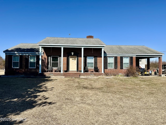 single story home with a porch and a front lawn