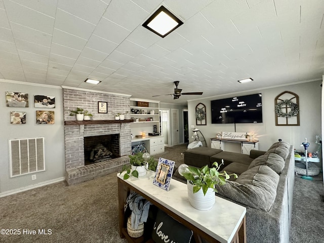 carpeted living room with crown molding, ceiling fan, and a brick fireplace