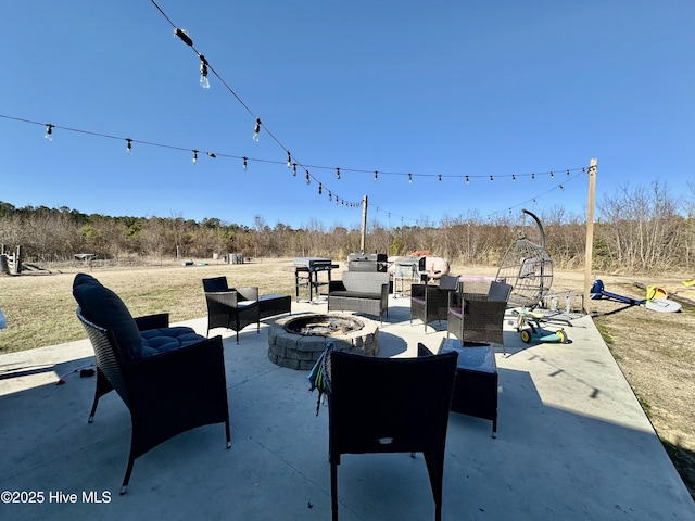 view of patio / terrace featuring an outdoor living space with a fire pit