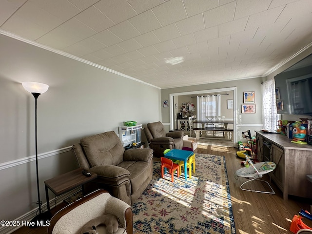 living room featuring hardwood / wood-style flooring and ornamental molding