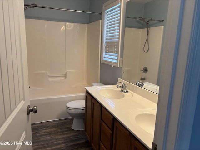 full bathroom with vanity, hardwood / wood-style floors, bathtub / shower combination, and toilet