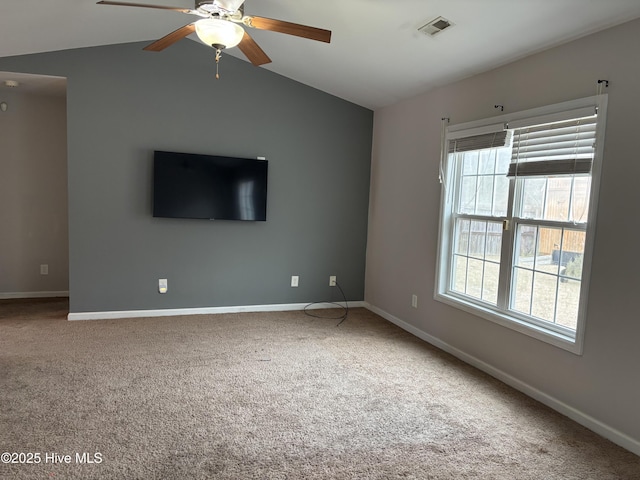 unfurnished living room featuring lofted ceiling, carpet flooring, and a wealth of natural light