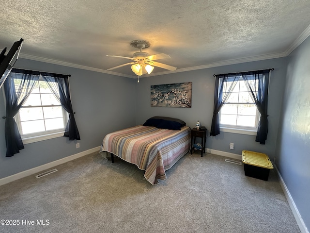 carpeted bedroom featuring visible vents, crown molding, a textured ceiling, and baseboards