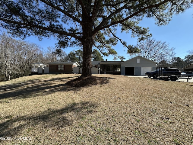 ranch-style house with a front yard, driveway, and an attached garage