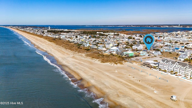 birds eye view of property with a water view and a view of the beach