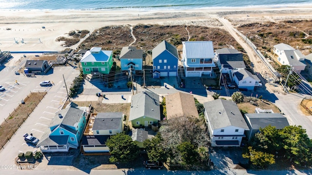 bird's eye view featuring a water view and a view of the beach