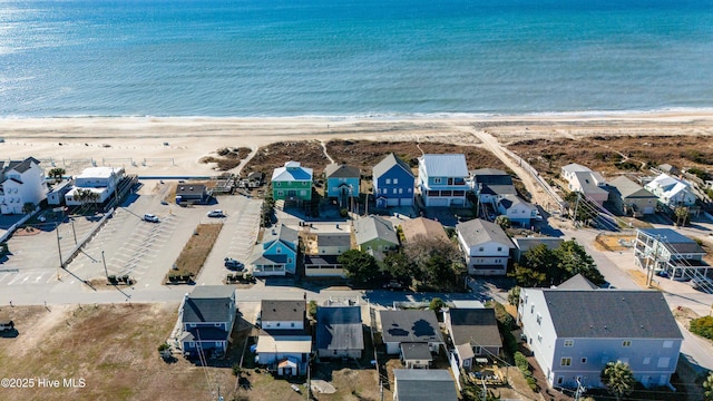 drone / aerial view with a water view and a view of the beach