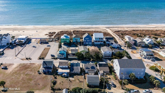 birds eye view of property with a water view and a view of the beach